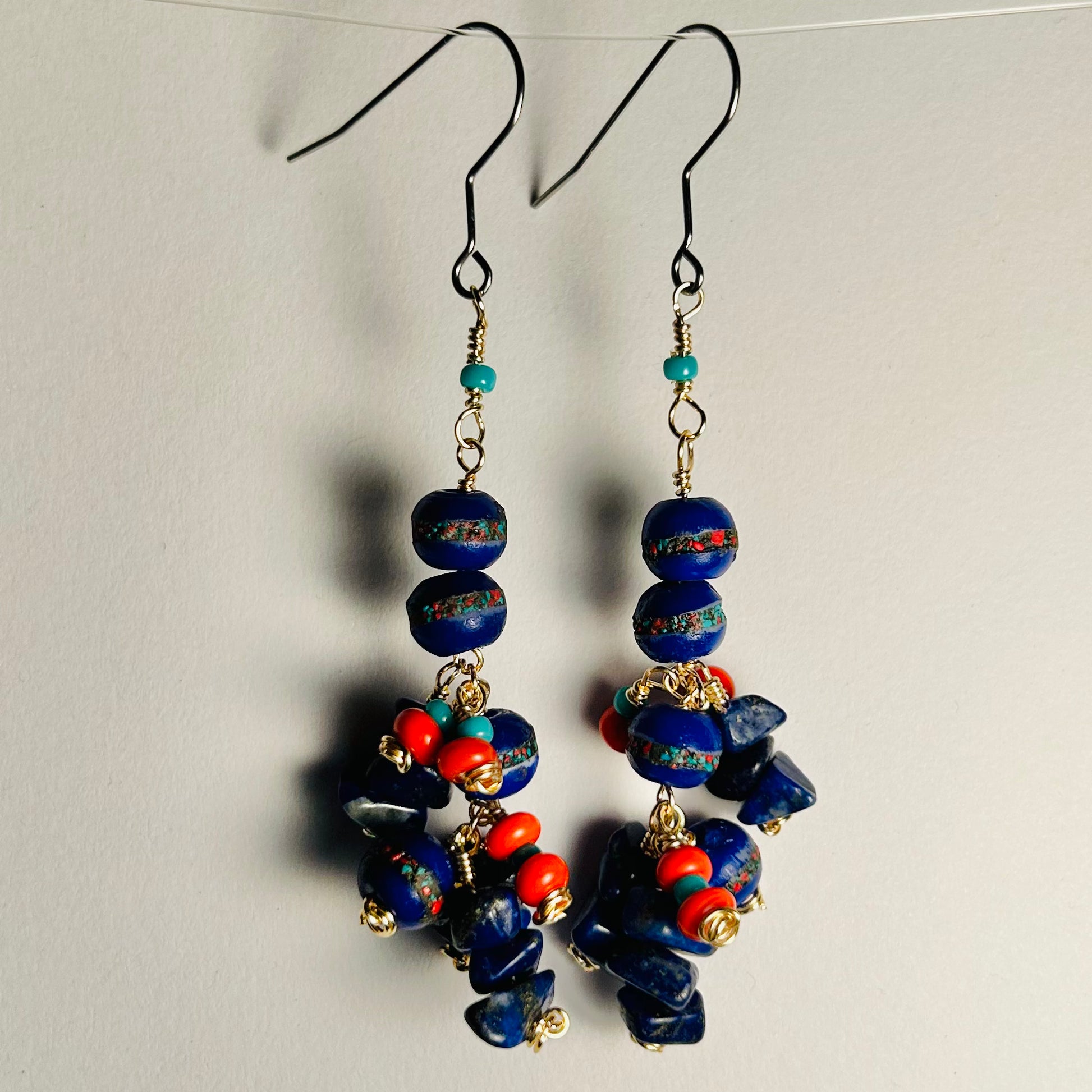 Handmade Pair of Beaded Earrings

 Surgical Steel Ear Wire, 2.5 inch long dangle

featuring Tibetan Hand Carved Cobalt Yak Bone Beads, Lapis Gemstone Chips, & Vintage Glass & Ceramic Beads upon Bare Copper Wire.