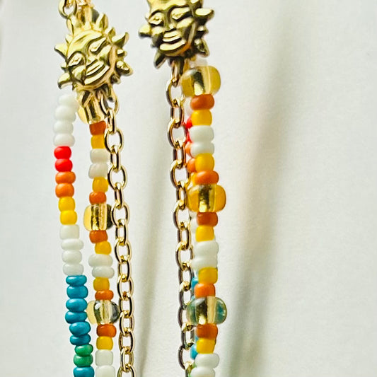 andmade Beaded Earrings, hypoallergenic surgical steel ear wire, 4.5 inches in length

Featuring raw brass sunshine charms, upcycled chain, & upcycled glass seed beads.

